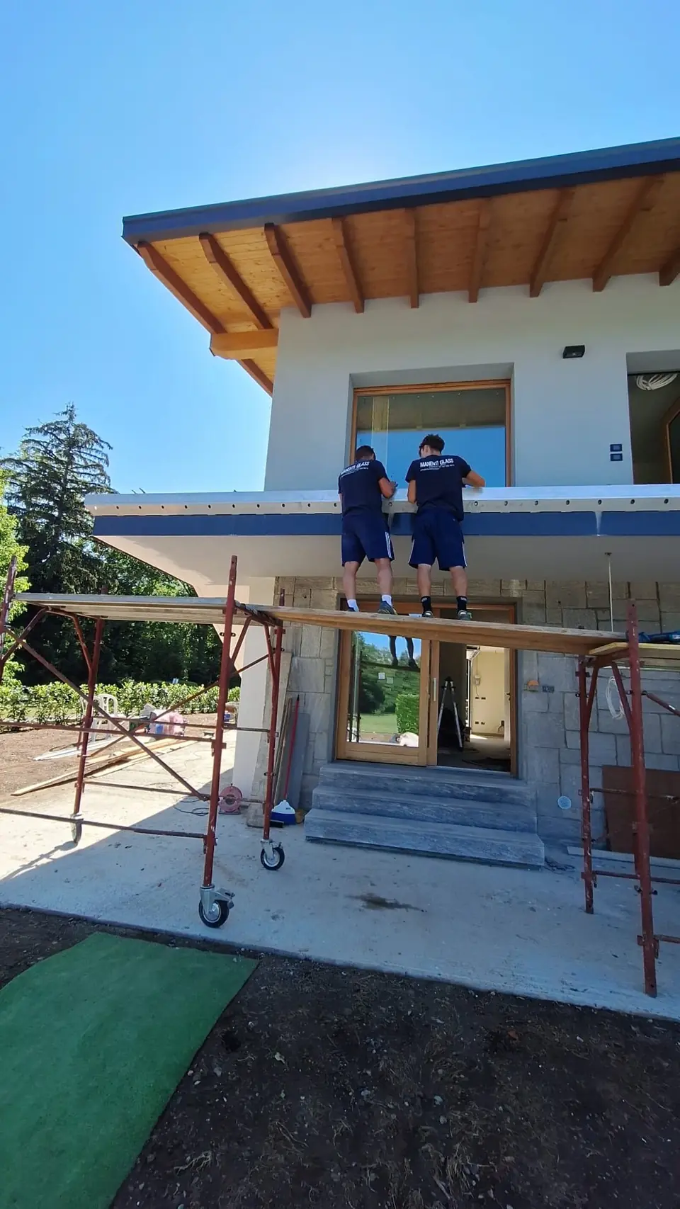 Cornice being fitted on a house facade