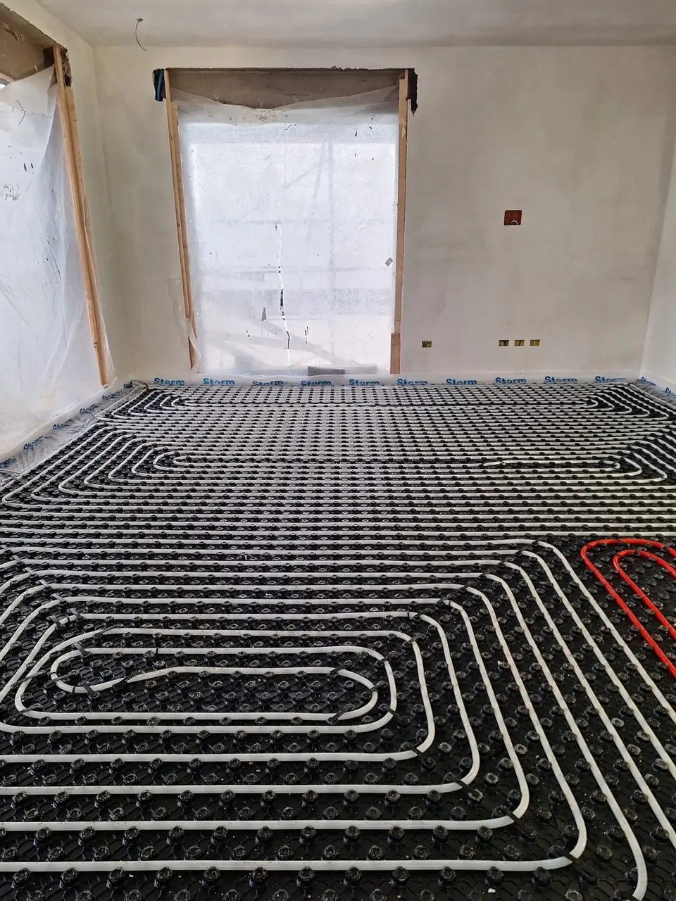 Underfloor heating being laid in a room