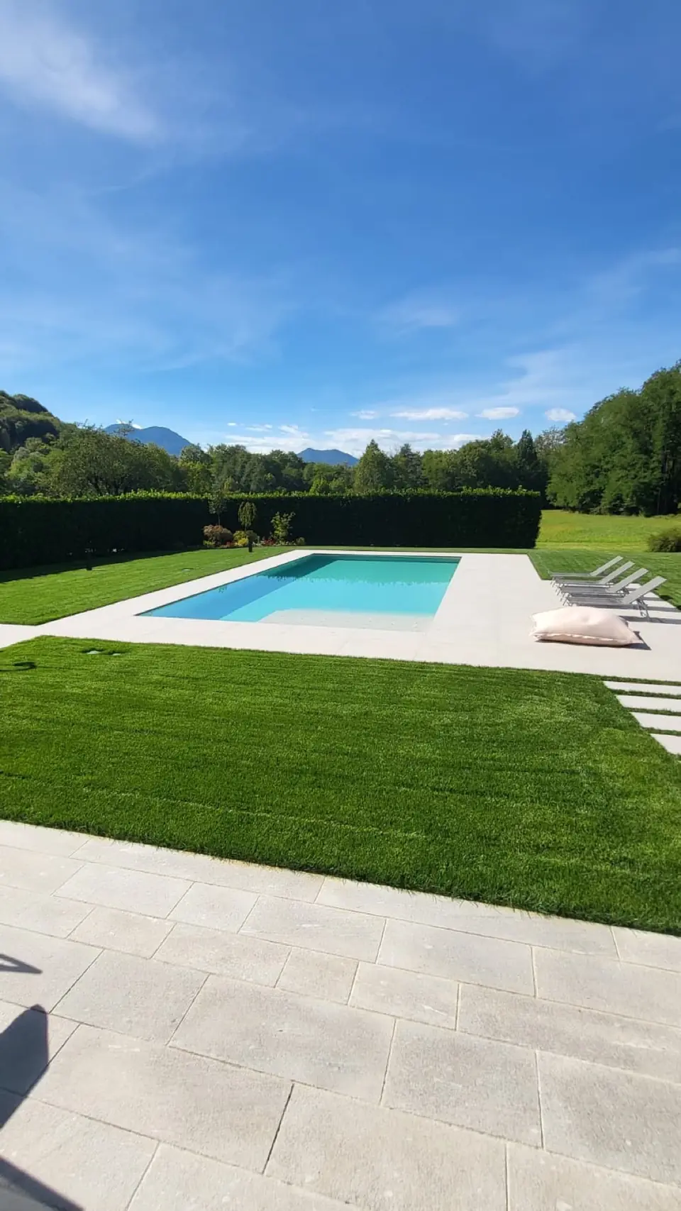New pool with lawn and light stone edge