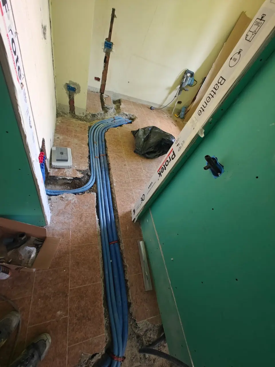 Electrical work in progress with junction boxes and drywall